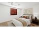 Bedroom featuring neutral carpet, window with wooden shutters, and tasteful decor at 1417 W Los Arboles Pl, Chandler, AZ 85224
