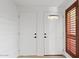 Entryway features two white doors and a side window at 1417 W Los Arboles Pl, Chandler, AZ 85224