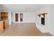 Spacious living room with tile flooring, brick fireplace, and natural light at 1417 W Los Arboles Pl, Chandler, AZ 85224
