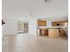 Open living room with access to kitchen, featuring tile flooring and lots of natural light at 1417 W Los Arboles Pl, Chandler, AZ 85224