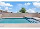 A refreshing pool with spa, set against a clear blue sky at 1417 W Los Arboles Pl, Chandler, AZ 85224