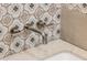Bathroom faucet with polished chrome finish against decorative patterned tile at 14518 N 99Th St, Scottsdale, AZ 85260