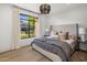 Sunlit bedroom with a large window overlooking the landscaped front yard at 14518 N 99Th St, Scottsdale, AZ 85260