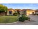 Beautiful home features desert landscaping, a terracotta roof, and an attached three-car garage at 14518 N 99Th St, Scottsdale, AZ 85260