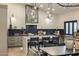 Modern kitchen with an island, pendant lighting, and custom cabinetry at 14518 N 99Th St, Scottsdale, AZ 85260