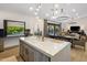 Bright kitchen with large island, stainless steel appliances and an open window to the pool at 14518 N 99Th St, Scottsdale, AZ 85260