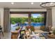Living room with large sectional couch, decor and sliding door to outdoor pool area at 14518 N 99Th St, Scottsdale, AZ 85260