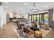 Open-concept living space with a comfortable seating area, modern lighting, and kitchen in the background at 14518 N 99Th St, Scottsdale, AZ 85260