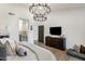 Bedroom with hardwood floors, TV on wall and chandelier at 14518 N 99Th St, Scottsdale, AZ 85260