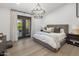 Bedroom with large bed, wood floors and double doors leading to outdoor area at 14518 N 99Th St, Scottsdale, AZ 85260
