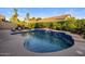 Serene swimming pool with tiled accents and a lush tropical garden backdrop at 14518 N 99Th St, Scottsdale, AZ 85260