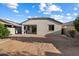 Wide backyard with covered patio offers space for outdoor activities and entertaining at 15844 W Lisbon Ln, Surprise, AZ 85379