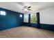 Well lit bedroom featuring plush carpeting, modern ceiling fan and bright window at 15844 W Lisbon Ln, Surprise, AZ 85379