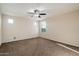 Neutral bedroom features carpet, a ceiling fan, and plenty of natural light at 15844 W Lisbon Ln, Surprise, AZ 85379