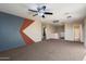 Large carpeted bonus room with ceiling fan and neutral wall color at 15844 W Lisbon Ln, Surprise, AZ 85379