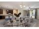 Dining area showcases table set and kitchen with island, sofa, and covered patio at 15844 W Lisbon Ln, Surprise, AZ 85379
