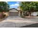 Charming single-story home featuring a neutral color scheme, well-maintained landscaping, and an attached two-car garage at 15844 W Lisbon Ln, Surprise, AZ 85379
