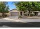 Charming single-story home featuring a neutral color scheme, well-maintained landscaping, and an attached two-car garage at 15844 W Lisbon Ln, Surprise, AZ 85379