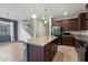 Open kitchen with island and view of staircase and living room at 15844 W Lisbon Ln, Surprise, AZ 85379