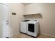 Laundry room featuring modern, front-loading washer and dryer appliances at 15844 W Lisbon Ln, Surprise, AZ 85379