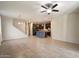 Open-concept living room showing staircase and kitchen with an island and pendant lighting at 15844 W Lisbon Ln, Surprise, AZ 85379