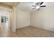 Open living area with tile flooring, neutral walls, ceiling fan and natural light from the window near the front door at 15844 W Lisbon Ln, Surprise, AZ 85379