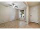 Open living area with tile flooring, neutral walls, ceiling fan and natural light from the window near the front door at 15844 W Lisbon Ln, Surprise, AZ 85379