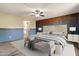 Stylish main bedroom showing decor headboard, bench and private bathroom at 15844 W Lisbon Ln, Surprise, AZ 85379