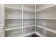 Walk-in pantry with multiple shelves for storage and a light-colored door at 15844 W Lisbon Ln, Surprise, AZ 85379