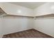 Walk-in closet with carpet, built-in shelving, and clothing rods at 15844 W Lisbon Ln, Surprise, AZ 85379