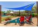 Relaxing backyard with a pool and shaded seating under blue shade sails at 17201 E Hillcrest Dr, Fountain Hills, AZ 85268