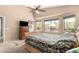Comfortable bedroom with plush bedding, dresser, and windows offering backyard view at 17201 E Hillcrest Dr, Fountain Hills, AZ 85268