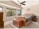 Bright bedroom with large windows, decorative chest, and a comfortable bed at 17201 E Hillcrest Dr, Fountain Hills, AZ 85268