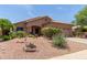 Charming single-story home featuring a well-manicured desert landscape with a cozy front porch at 17201 E Hillcrest Dr, Fountain Hills, AZ 85268