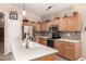 Bright kitchen featuring stainless steel appliances, tile backsplash, and a spacious island with sink at 17201 E Hillcrest Dr, Fountain Hills, AZ 85268