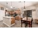 Well-lit kitchen featuring an island, wooden cabinetry, modern appliances, and an adjacent dining area at 17201 E Hillcrest Dr, Fountain Hills, AZ 85268