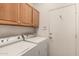 Bright laundry room with washer, dryer, and overhead cabinets at 17201 E Hillcrest Dr, Fountain Hills, AZ 85268