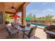 Covered patio with comfortable seating and an outdoor grill, perfect for poolside entertaining at 17201 E Hillcrest Dr, Fountain Hills, AZ 85268
