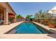 Sparkling pool surrounded by desert landscaping and seating areas at 17201 E Hillcrest Dr, Fountain Hills, AZ 85268