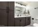 Stylish bathroom with a large vanity, modern mirror, updated lighting, and convenient storage cabinets at 1743 W Acoma Dr, Phoenix, AZ 85023