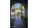 Wrought iron gate leads to front porch with red tile, and decorative wreath adorns the entryway at 1743 W Acoma Dr, Phoenix, AZ 85023