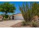 Charming single-story home featuring desert landscaping, a two-car garage, and an arched front entry gate at 1743 W Acoma Dr, Phoenix, AZ 85023