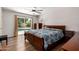Comfortable bedroom with hardwood floors, sliding glass doors to the pool, and classic wooden furniture at 1743 W Acoma Dr, Phoenix, AZ 85023