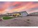 Spacious backyard featuring artificial turf, a covered patio and desert landscaping at 17721 W Sandalwood Dr, Goodyear, AZ 85338