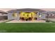 Inviting covered patio with outdoor seating, a grill, and a lush green lawn, perfect for entertaining and relaxing at 17721 W Sandalwood Dr, Goodyear, AZ 85338