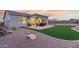 Inviting backyard featuring a covered patio, artificial turf, and low-maintenance landscaping for outdoor relaxation at 17721 W Sandalwood Dr, Goodyear, AZ 85338