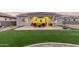 Wonderful backyard featuring a covered patio, a grill, and lush green synthetic grass at 17721 W Sandalwood Dr, Goodyear, AZ 85338