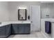Well-lit bathroom features modern vanity with ample storage and a large mirror, offering a clean and stylish space at 17721 W Sandalwood Dr, Goodyear, AZ 85338