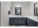 Bathroom boasts dual sink vanity with gray cabinets and a framed mirror at 17721 W Sandalwood Dr, Goodyear, AZ 85338