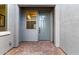 Close-up of the front entrance with brick pavers, a gray door, and a window for natural light at 17721 W Sandalwood Dr, Goodyear, AZ 85338